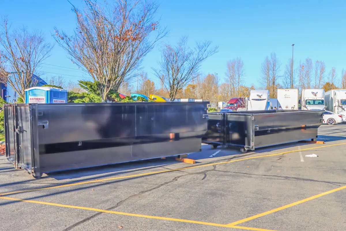 Professional dumpster rental service with roll-off container on residential driveway in Peachtree City